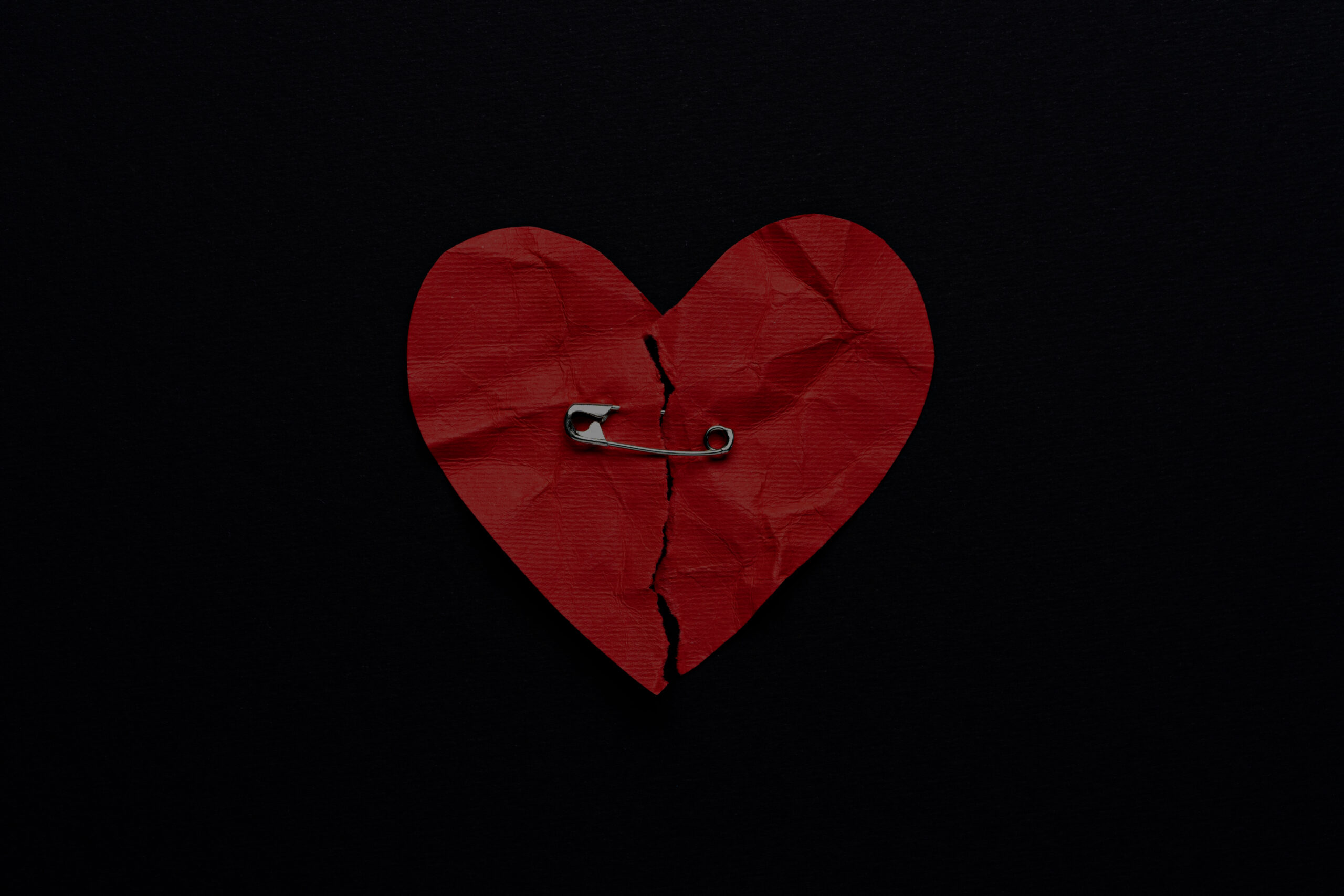 top-view-broken-heart-with-safety-pin